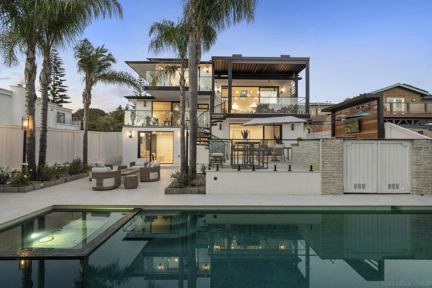 Renovated Del Mar home with pool at dusk.